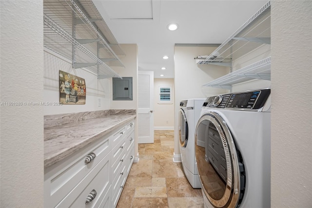 laundry room with independent washer and dryer, stone tile flooring, electric panel, and recessed lighting