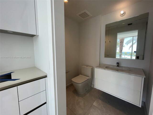 18501 Collins Ave Unit 22, Sunny Isles Beach, FL 33160 - bathroom featuring vanity, toilet, and tile patterned floors