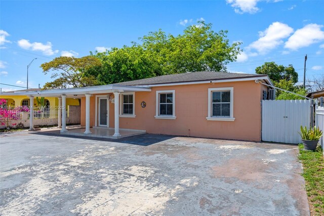911 E 32nd St, Hialeah, FL 33013 - view of front of property with fence and stucco siding