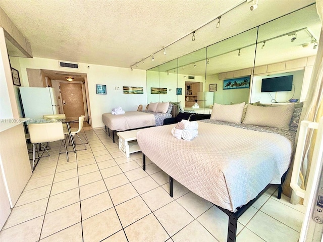 19201 Collins Ave Unit 606, Sunny Isles Beach, FL 33160 - bedroom featuring light tile patterned floors and a textured ceiling