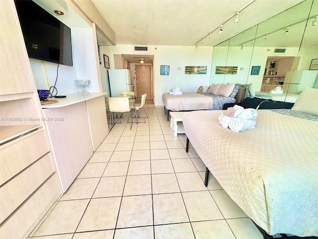 19201 Collins Ave Unit 606, Sunny Isles Beach, FL 33160 - bedroom featuring light tile patterned floors and freestanding refrigerator