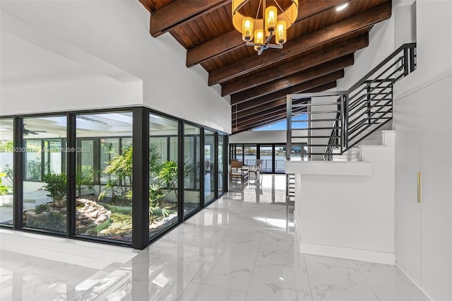 stairway with wood ceiling, a chandelier, marble look tiles, and baseboards