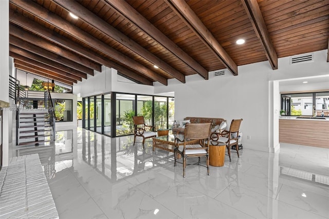 view of patio / terrace featuring a sunroom and stairs