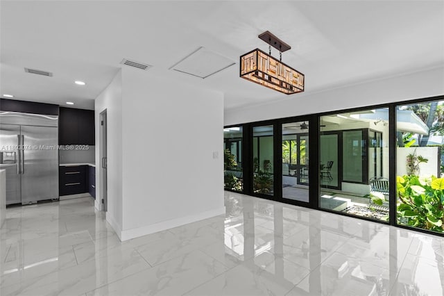 unfurnished room with light marble finish floors, baseboards, and recessed lighting