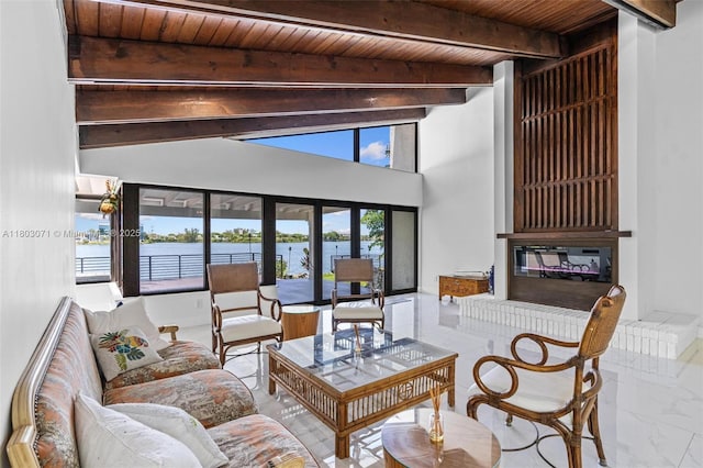living room with beamed ceiling, wood ceiling, marble finish flooring, and a water view