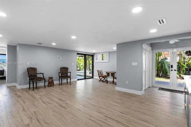 sitting room with french doors, recessed lighting, light wood-style flooring, baseboards, and healthy amount of natural light