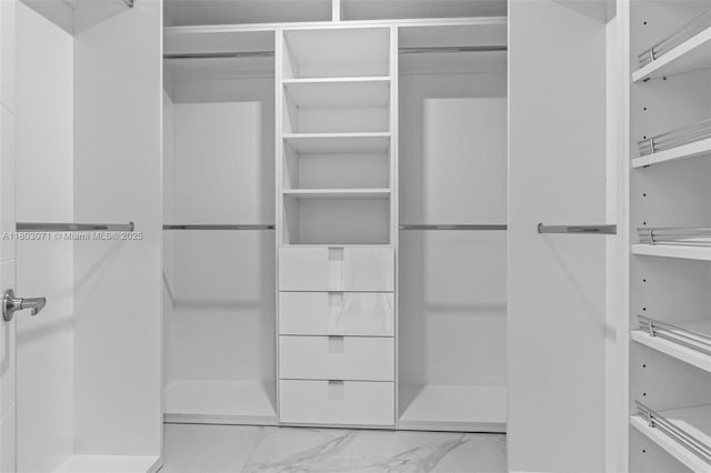 spacious closet with marble finish flooring