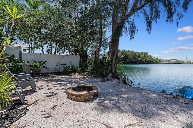 view of patio / terrace with a fire pit and a water view