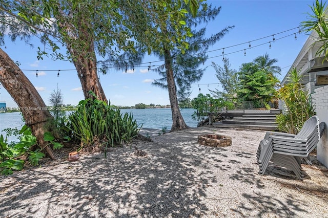 view of patio / terrace featuring a fire pit and a water view