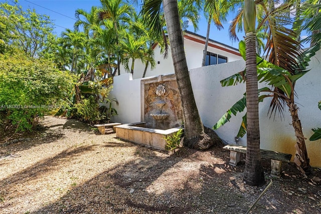 view of side of home featuring stucco siding