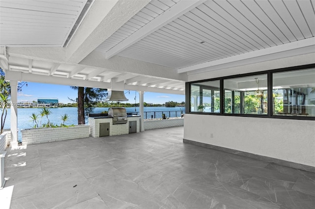 view of patio / terrace with area for grilling, grilling area, and a water view