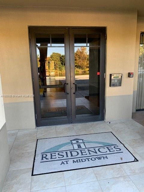 4907 Midtown Ln Unit 1113, Palm Beach Gardens, FL 33418 - property entrance with french doors and stucco siding