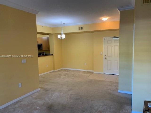 4907 Midtown Ln Unit 1113, Palm Beach Gardens, FL 33418 - spare room with ornamental molding, light carpet, and baseboards