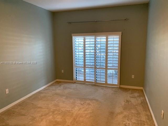 4907 Midtown Ln Unit 1113, Palm Beach Gardens, FL 33418 - spare room featuring carpet floors and baseboards