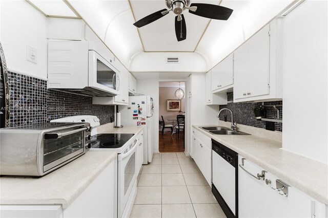 4330 Hillcrest Dr Unit 505, Hollywood, FL 33021 - kitchen with white appliances, a sink, light tile patterned floors, and white cabinets