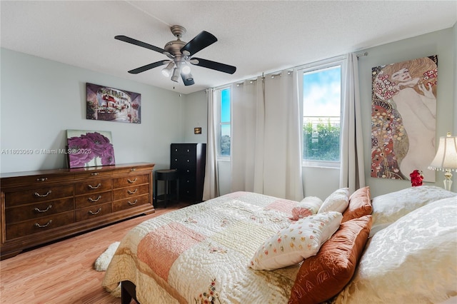 4330 Hillcrest Dr Unit 505, Hollywood, FL 33021 - bedroom featuring light wood-type flooring, a ceiling fan, and a textured ceiling