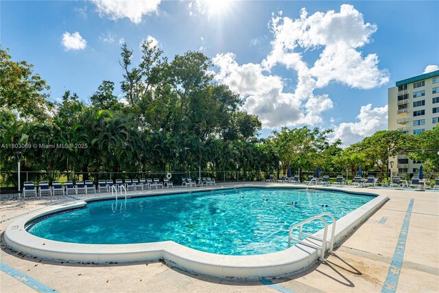 4330 Hillcrest Dr Unit 505, Hollywood, FL 33021 - community pool featuring fence, a patio area, and view of scattered trees