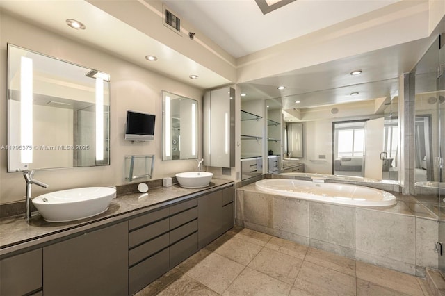 450 Alton Rd Unit 2303, Miami Beach, FL 33139 - bathroom featuring a garden tub, double vanity, recessed lighting, and a shower stall