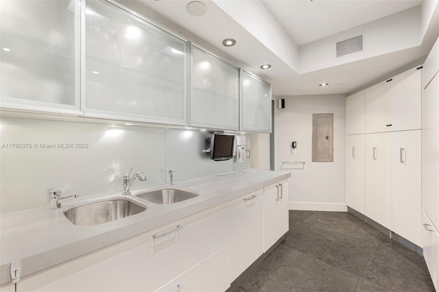 450 Alton Rd Unit 2303, Miami Beach, FL 33139 - kitchen with light countertops, white cabinets, recessed lighting, modern cabinets, and glass insert cabinets