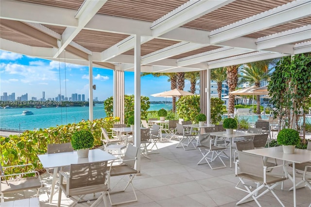 450 Alton Rd Unit 2303, Miami Beach, FL 33139 - view of patio with outdoor dining space, a water view, and a view of skyline