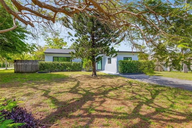 1998 NE 180th St, North Miami Beach, FL 33162 - view of property hidden behind natural elements featuring stucco siding