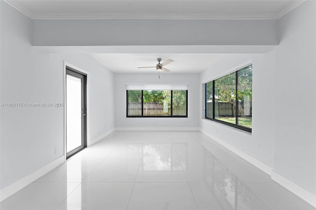 1998 NE 180th St, North Miami Beach, FL 33162 - empty room featuring plenty of natural light, a ceiling fan, baseboards, light tile patterned floors, and ornamental molding