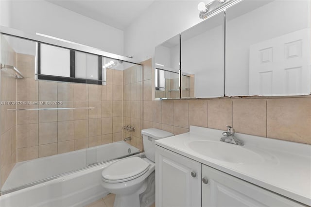 1998 NE 180th St, North Miami Beach, FL 33162 - full bath with toilet, backsplash, tile walls, vanity, and bath / shower combo with glass door