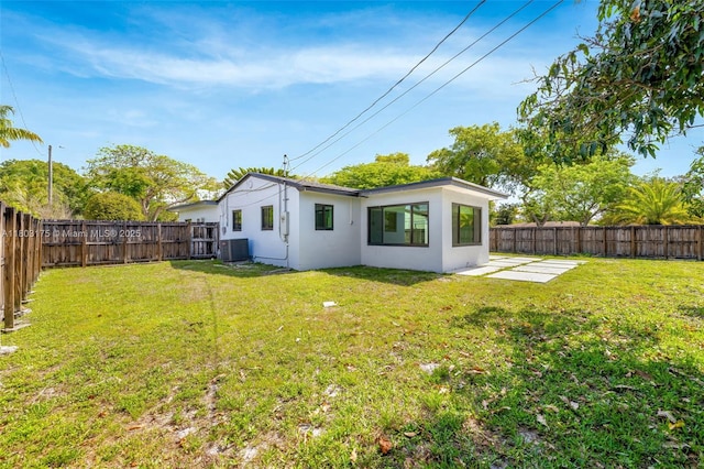 1998 NE 180th St, North Miami Beach, FL 33162 - rear view of property featuring central air condition unit, stucco siding, and a patio area