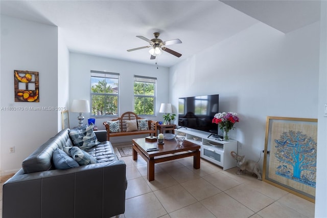 living area featuring ceiling fan and light tile patterned flooring