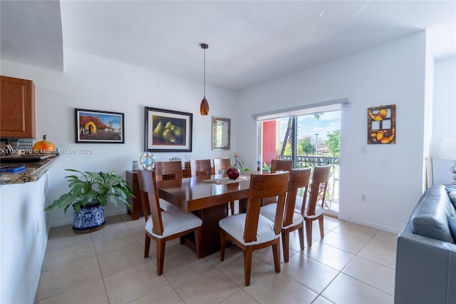 dining space with baseboards and light tile patterned flooring