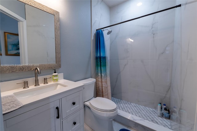bathroom with a stall shower, toilet, and vanity