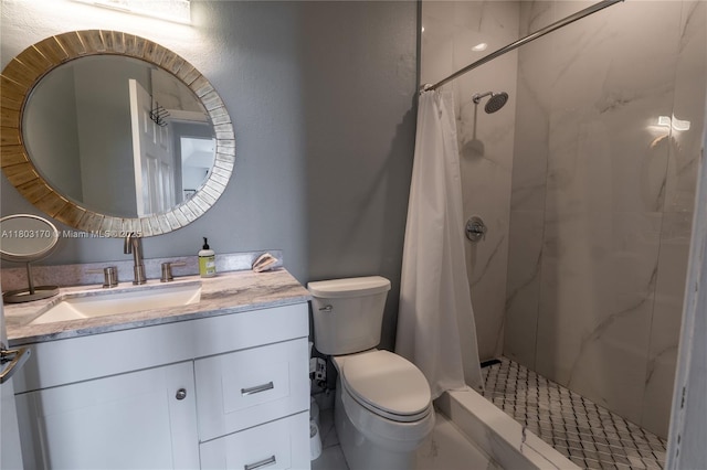 bathroom with toilet, vanity, and a shower stall