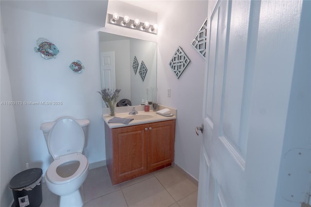bathroom with tile patterned flooring, vanity, and toilet