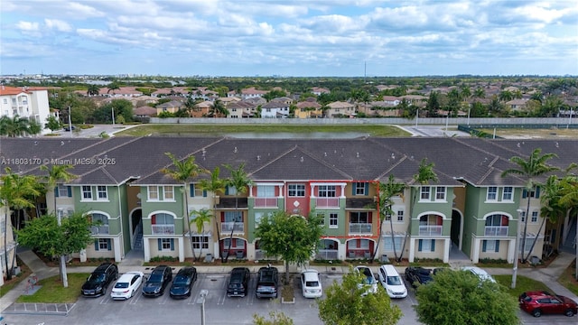 view of property with uncovered parking and a residential view