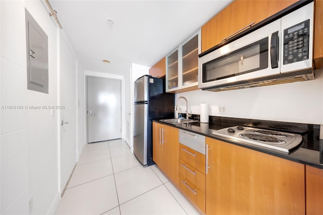 1750 N Bayshore Dr Unit 3308, Miami, FL 33132 - kitchen featuring stainless steel appliances, a sink, dark countertops, glass insert cabinets, and light tile patterned flooring