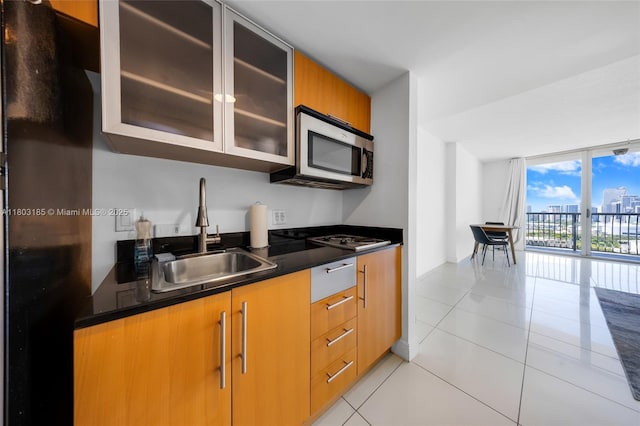 1750 N Bayshore Dr Unit 3308, Miami, FL 33132 - kitchen with a sink, stainless steel appliances, dark countertops, light tile patterned floors, and expansive windows