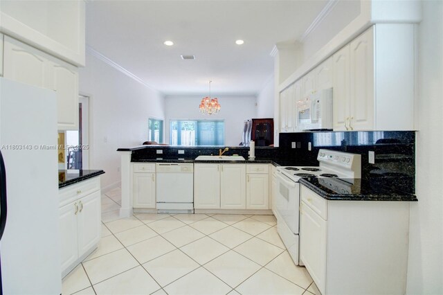 9072 NW 145th St, Miami Lakes, FL 33018 - kitchen with white appliances, a peninsula, crown molding, tasteful backsplash, and a chandelier