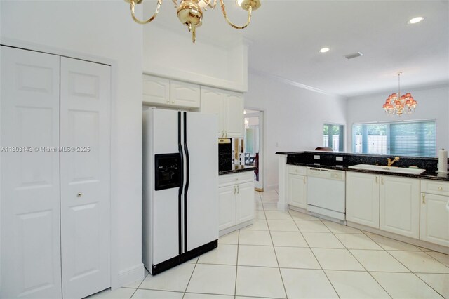 9072 NW 145th St, Miami Lakes, FL 33018 - kitchen featuring a chandelier, white appliances, a sink, dark countertops, and white cabinetry