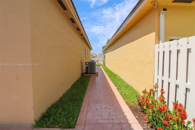 9072 NW 145th St, Miami Lakes, FL 33018 - view of side of home featuring stucco siding and central AC unit