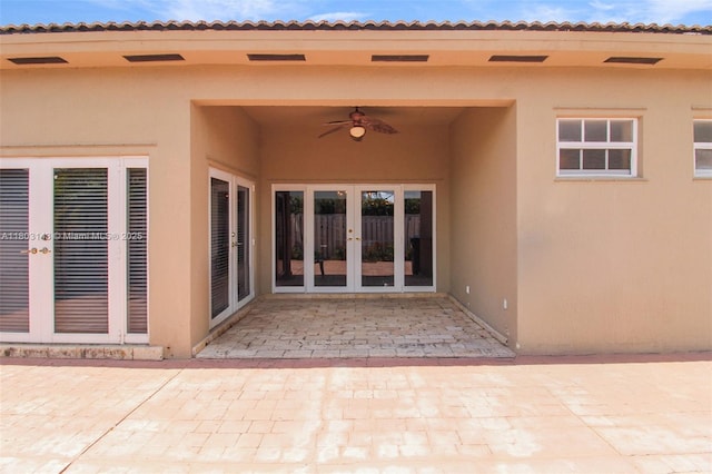 9072 NW 145th St, Miami Lakes, FL 33018 - view of exterior entry featuring french doors, stucco siding, ceiling fan, and a patio area