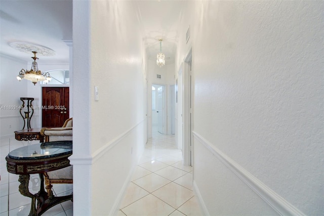 9072 NW 145th St, Miami Lakes, FL 33018 - hallway with a chandelier, light tile patterned floors, a textured wall, and baseboards