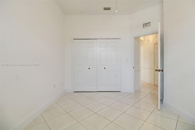9072 NW 145th St, Miami Lakes, FL 33018 - unfurnished bedroom with light tile patterned floors, baseboards, a closet, and ornamental molding