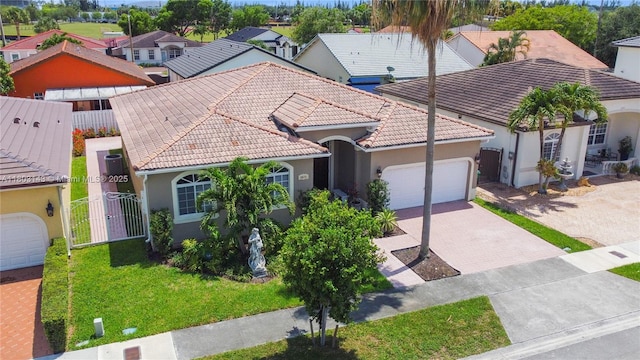 9072 NW 145th St, Miami Lakes, FL 33018 - mediterranean / spanish-style home with stucco siding, a tile roof, an attached garage, and decorative driveway
