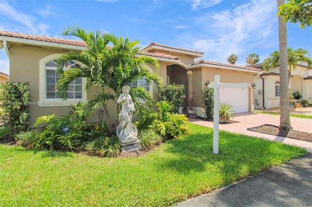 9072 NW 145th St, Miami Lakes, FL 33018 - mediterranean / spanish house featuring stucco siding, concrete driveway, an attached garage, and a front yard