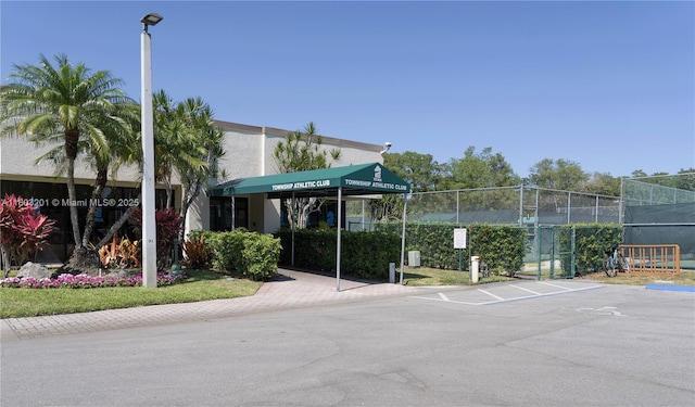 2903 S Carambola Cir S Unit 2094, Coconut Creek, FL 33066 - view of property featuring fence and uncovered parking