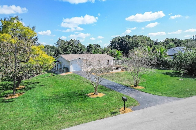 5200 SW 199th Ave, Southwest Ranches, FL 33332 - view of front of property with driveway, a front yard, a garage, and view of scattered trees