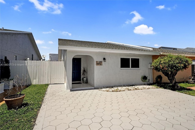 857 W 37th St, Hialeah, FL 33012 - rear view of property featuring stucco siding and a patio area