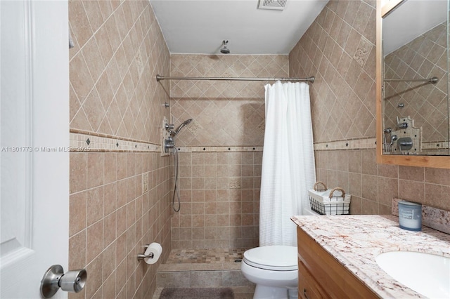 857 W 37th St, Hialeah, FL 33012 - full bathroom with tile walls, a tile shower, vanity, and toilet
