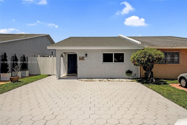 857 W 37th St, Hialeah, FL 33012 - view of front of house with stucco siding, decorative driveway, roof with shingles, and a patio