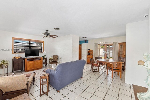 17331 SW 119th Ave, Miami, FL 33177 - living area with a chandelier, a ceiling fan, light tile patterned floors, and baseboards